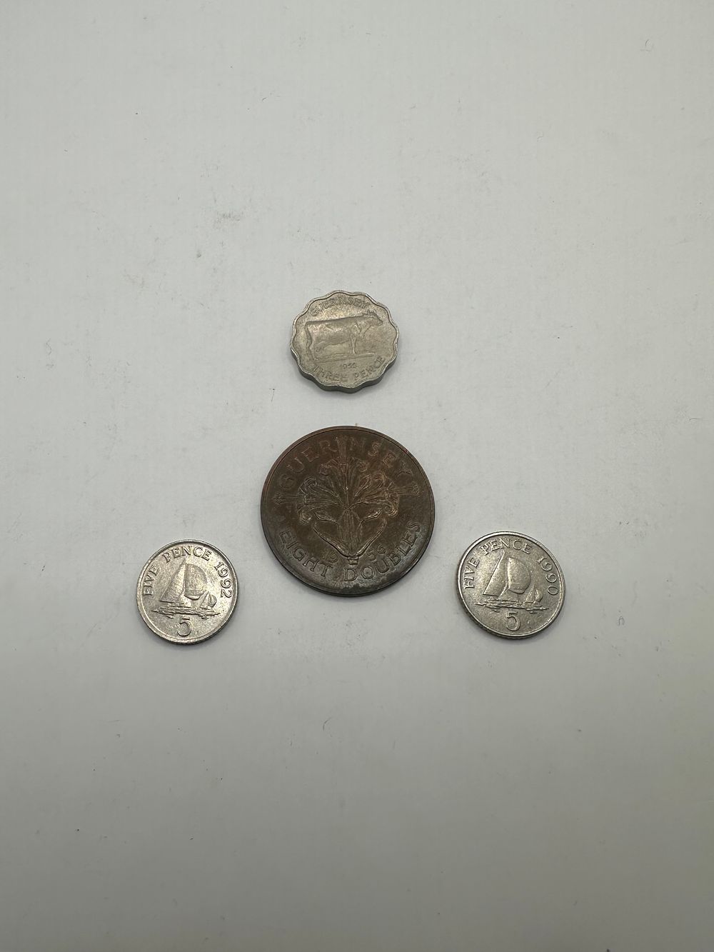 Lot 477: A Group of Four Guernsey Coins, Mid-to-Late 20th Century