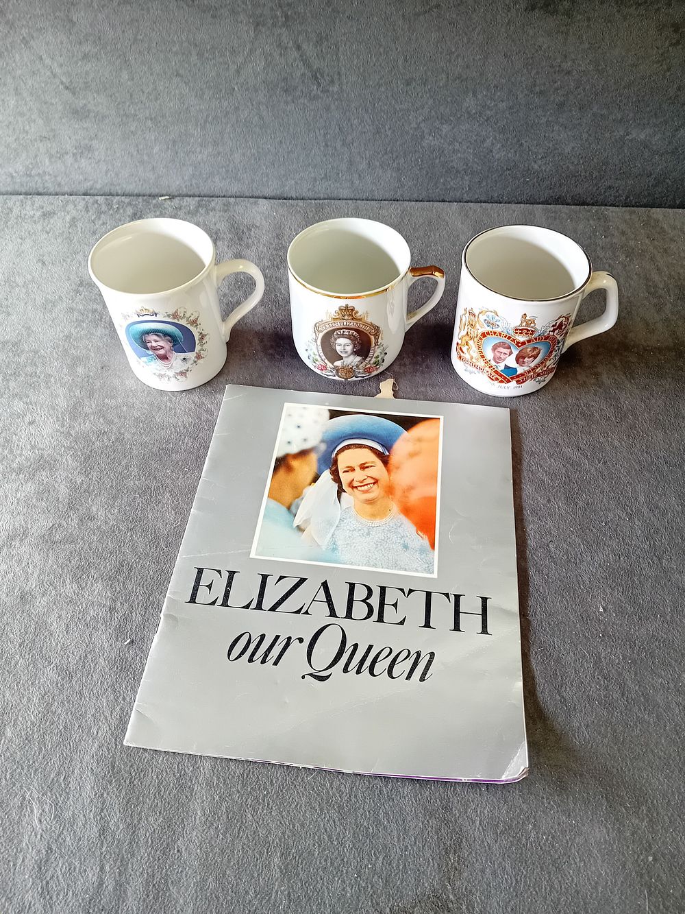 Lot 255: A COLLECTION OF BRITISH ROYAL FAMILY COMMEMORATIVE MUGS AND BOOK