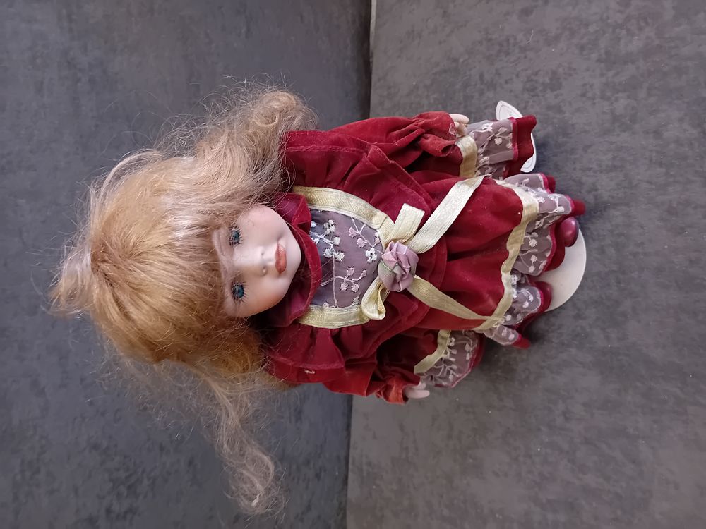 Lot 307: Leonardo Collector's Porcelain Doll in Red Velvet Style Dress
