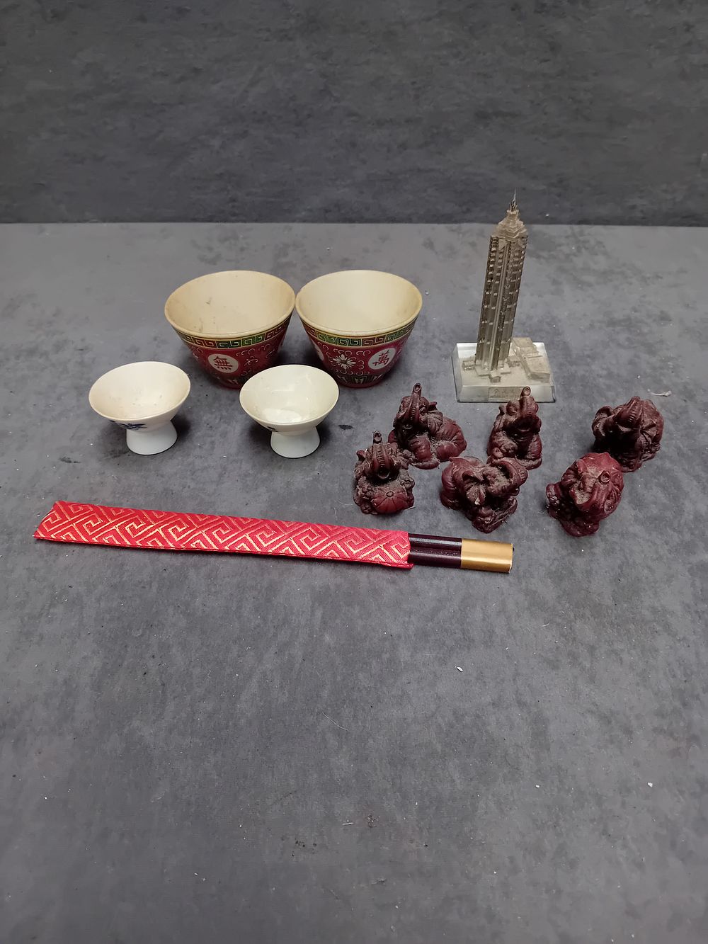 Lot 516: An Assortment of Asian Decorative Objects and Souvenirs Including Porcelain Cups and Architectural Model