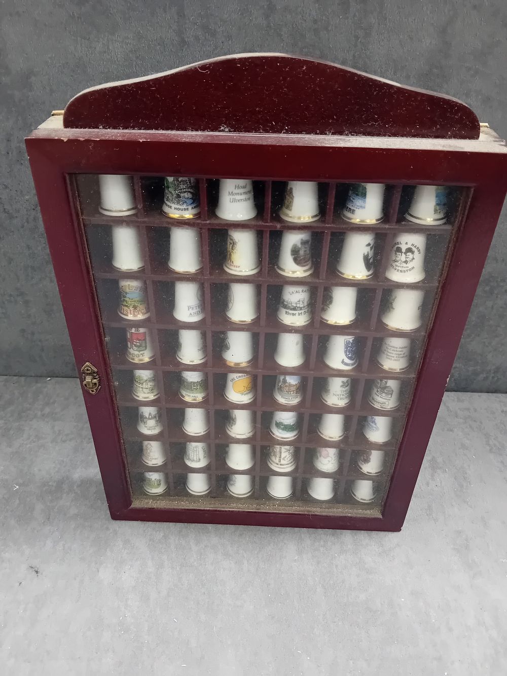 Lot 562: A Modern Collection of 49 British Souvenir Thimbles in a Wooden Display Case
