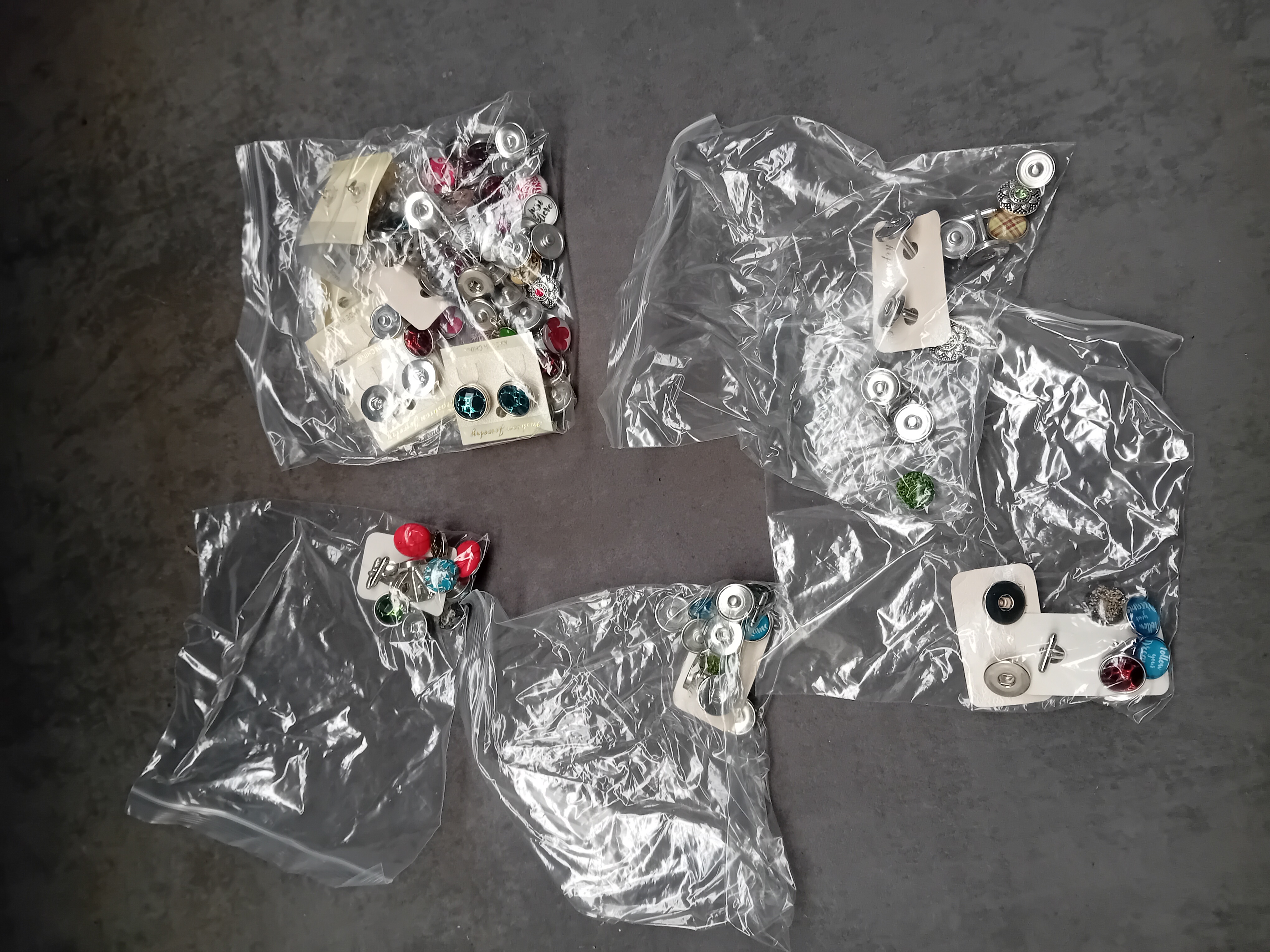 A Collection of Five Bags of Assorted Interchangeable Snap Button Jewelry Components