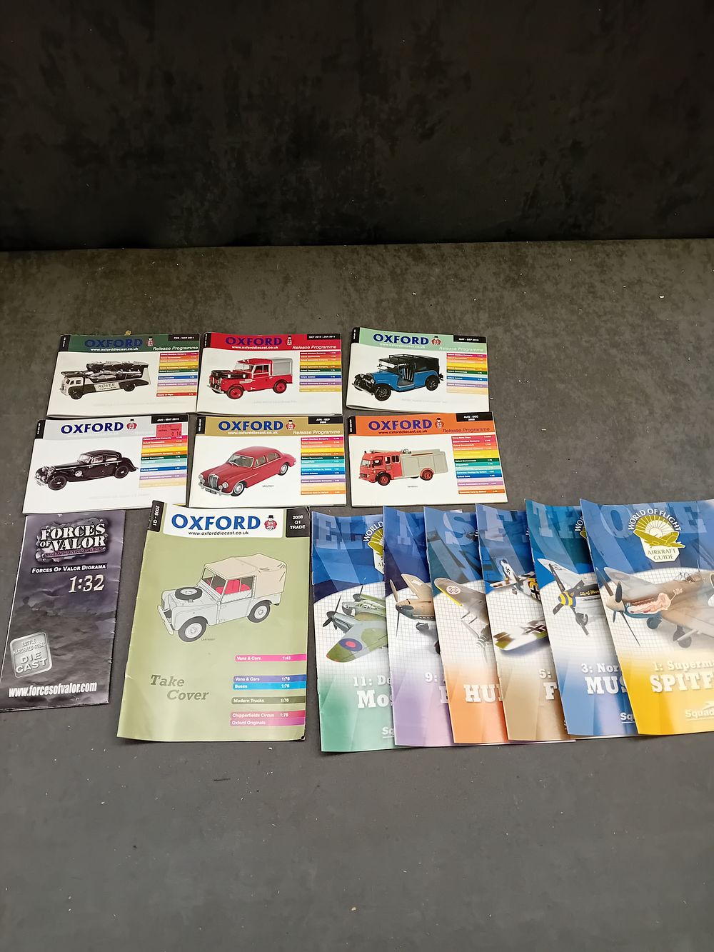 Lot 217: A Collection of Approximately Two Dozen Printed Paper Booklets and Catalogs, including Oxford Diecast, Squadron, and Forces of Valor