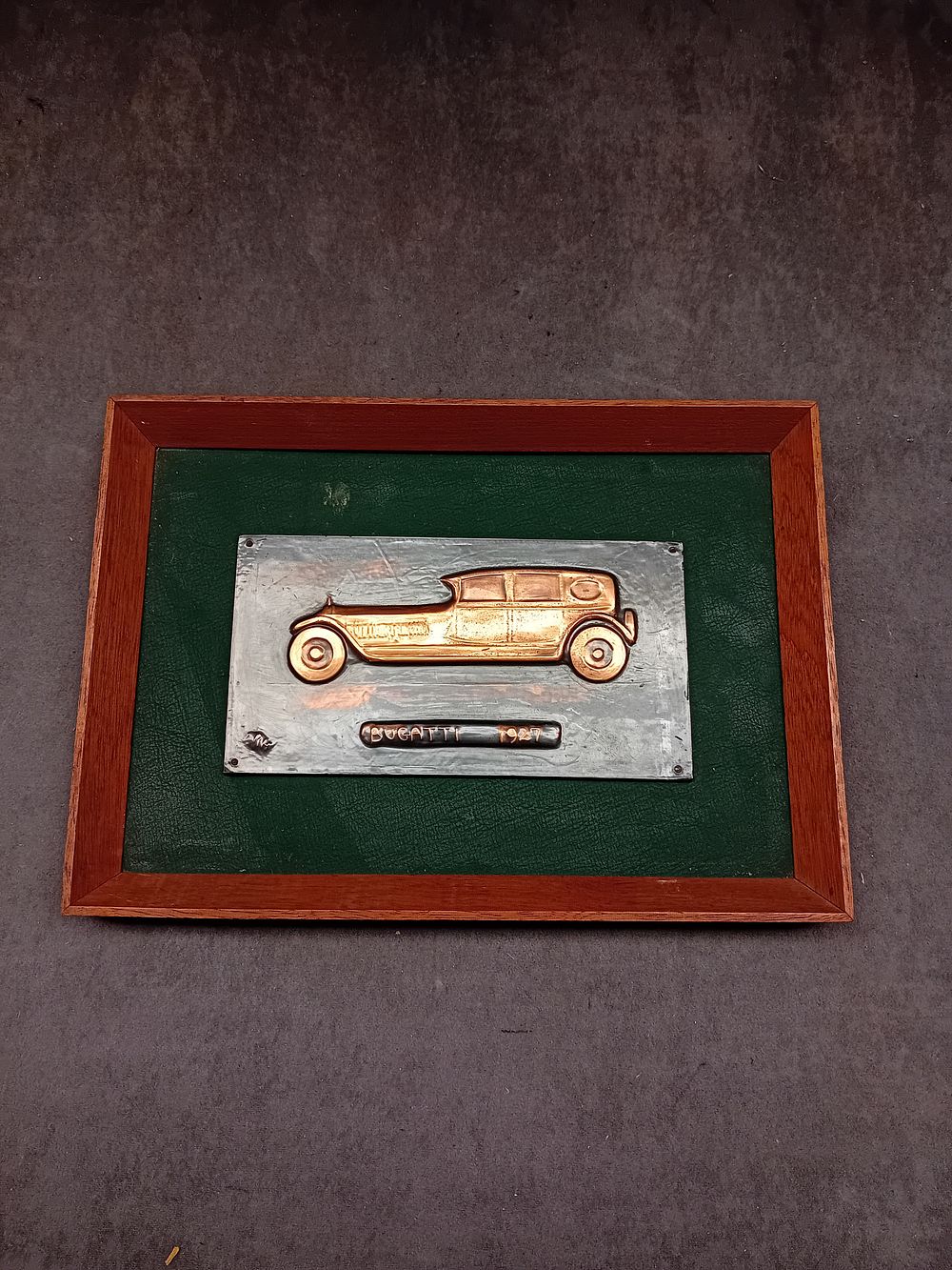 Lot 79: A Framed Metal Wall Plaque depicting a 1927 Bugatti, Hand Wrought by Arthur J. Gaskin