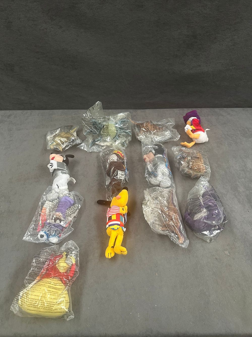 Lot 194: A Collection of Thirteen Vintage McDonald's Disney Happy Meal Plush Toys
