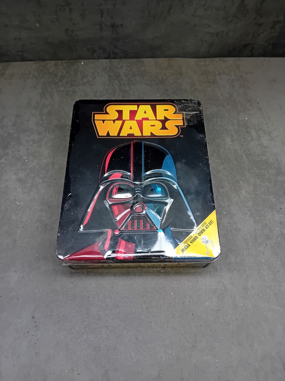 Lot 265: Star Wars: Lucasfilm Ltd. Collectible Metal Tin, AT-ST Model Making Kit & Activity Book, Original Seal