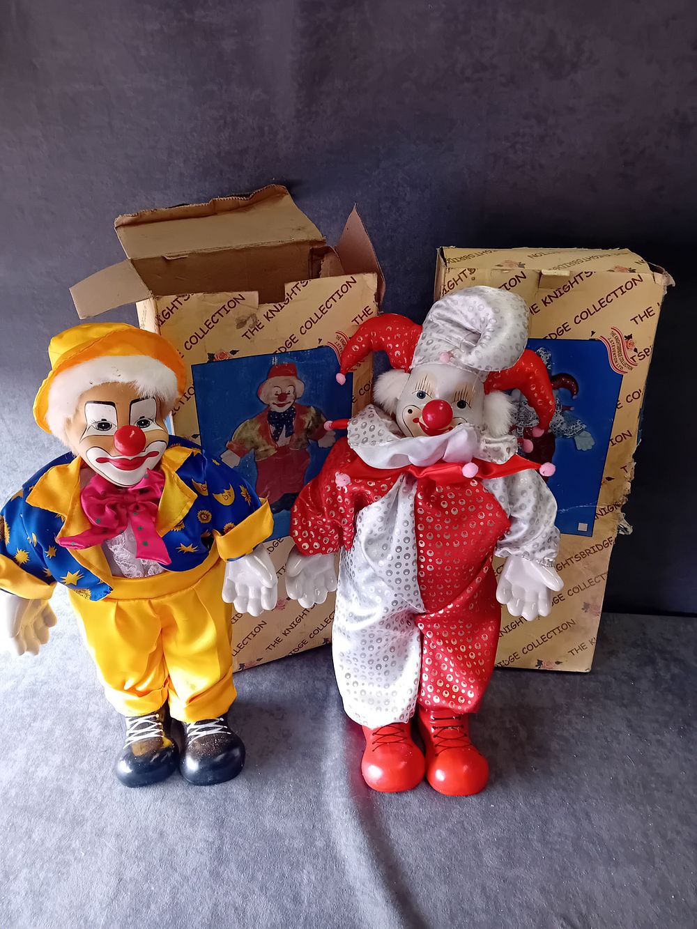 Lot 565: A PAIR OF KNIGHTSBRIDGE COLLECTION PORCELAIN CLOWN DOLLS