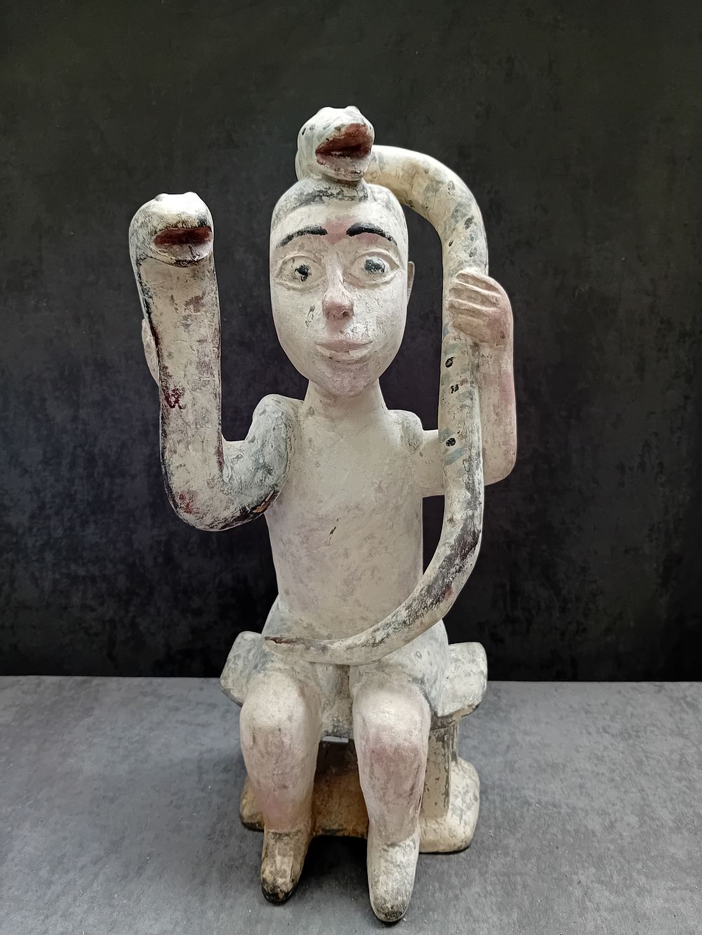 Lot 617: Ghana Fante seated figure Holding 2 Snakes 44cm...