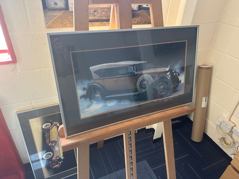 Lot 353: A Pair of Framed Photographic Prints of Vintage Automobiles including a 1929 Packard Phaeton