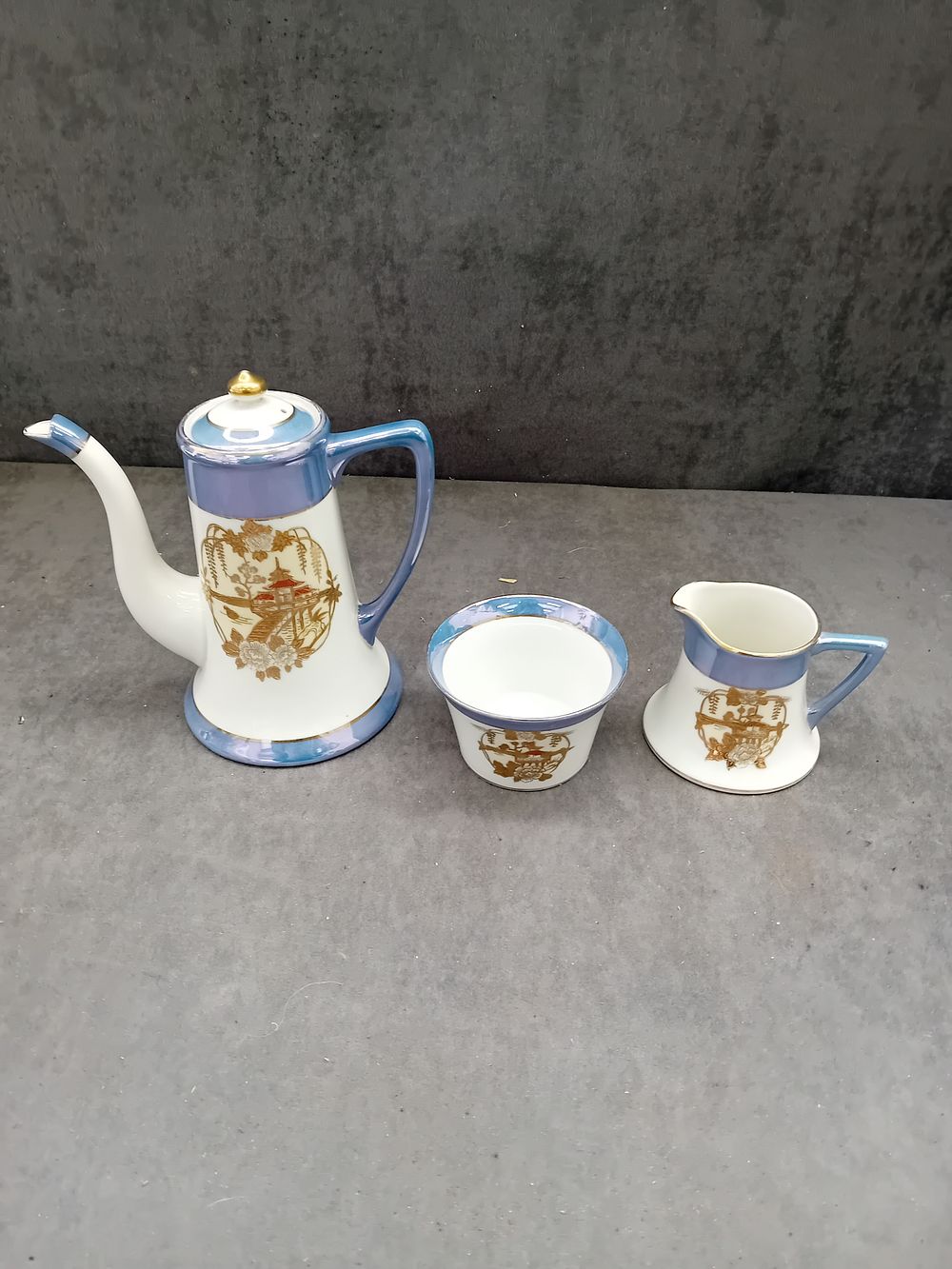 Lot 453: Noritake Three-Piece Porcelain Tea Set with Gilded Asian Landscape Decoration