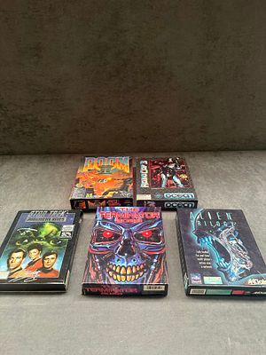 A collection of five vintage big box PC computer games including Doom II and The Terminator 2029. 
