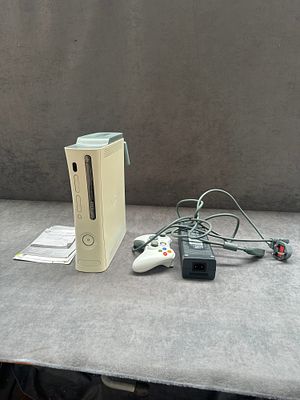 A Microsoft Xbox 360 HDMI video game console with wireless controller and accessories. A 