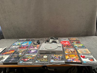 A Collection of Sony PlayStation Video Game Equipment and Twenty-Five Software Items. This lot 
