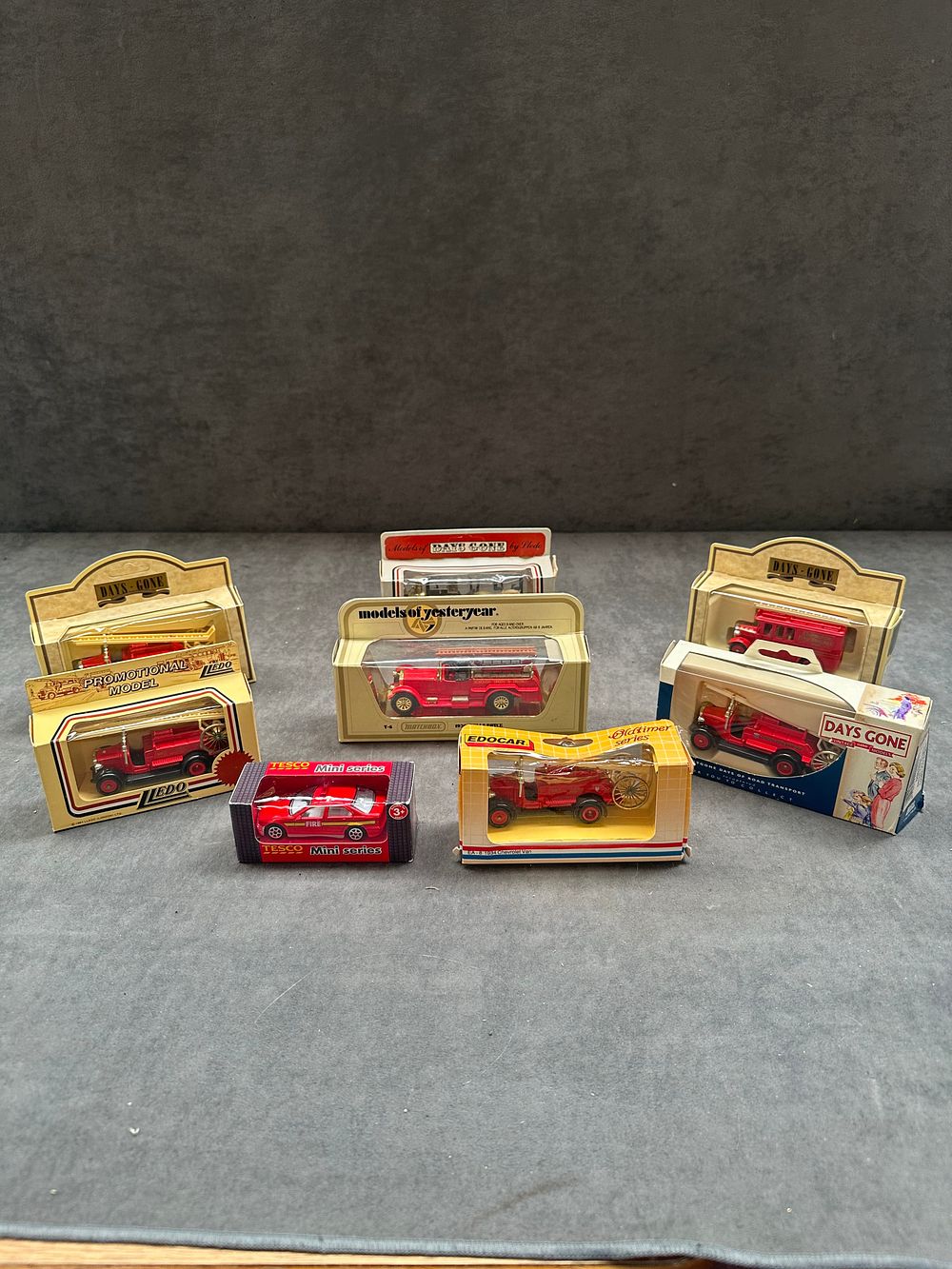 Lot 140: Eight Boxed Die-cast Model Fire Brigade Vehicles by Lledo, Matchbox, and Edocar
