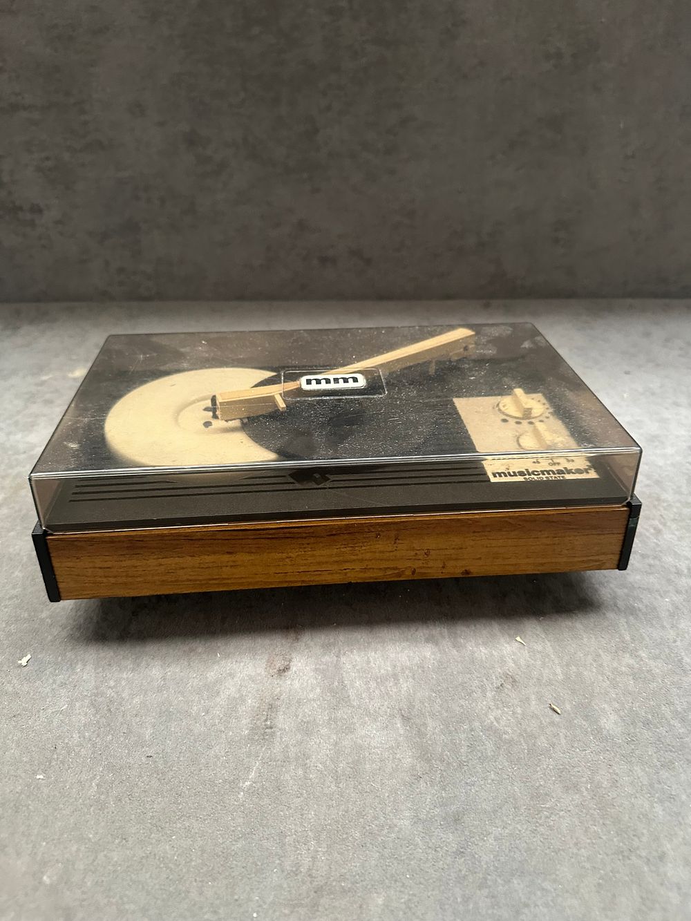 Lot 350: A vintage Musicmaker Solid State portable record player with teak veneer casing