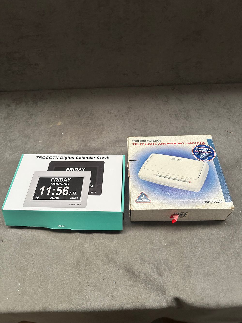 Lot 352: Two boxed electronic items including a Morphy Richards TX 200 telephone answering machine and a TROCOTN digital calendar clock