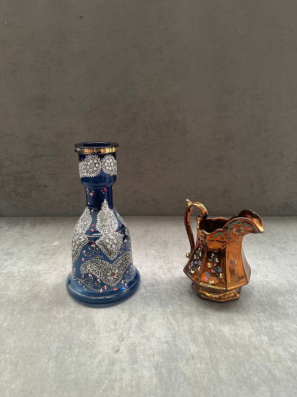 Lot 400: Two Decorative Items comprising a Copper Lustre Ceramic Pitcher and a Cobalt Blue Enameled Glass Vase