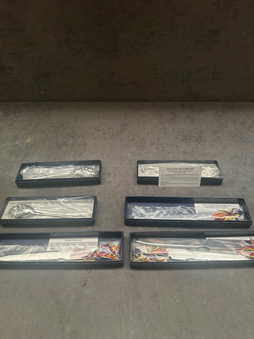 Lot 472: A Group of Three English Silverware Silver-Plated Berry Spoons and Three Sterling Silver Millennium Commemorative Letter Openers