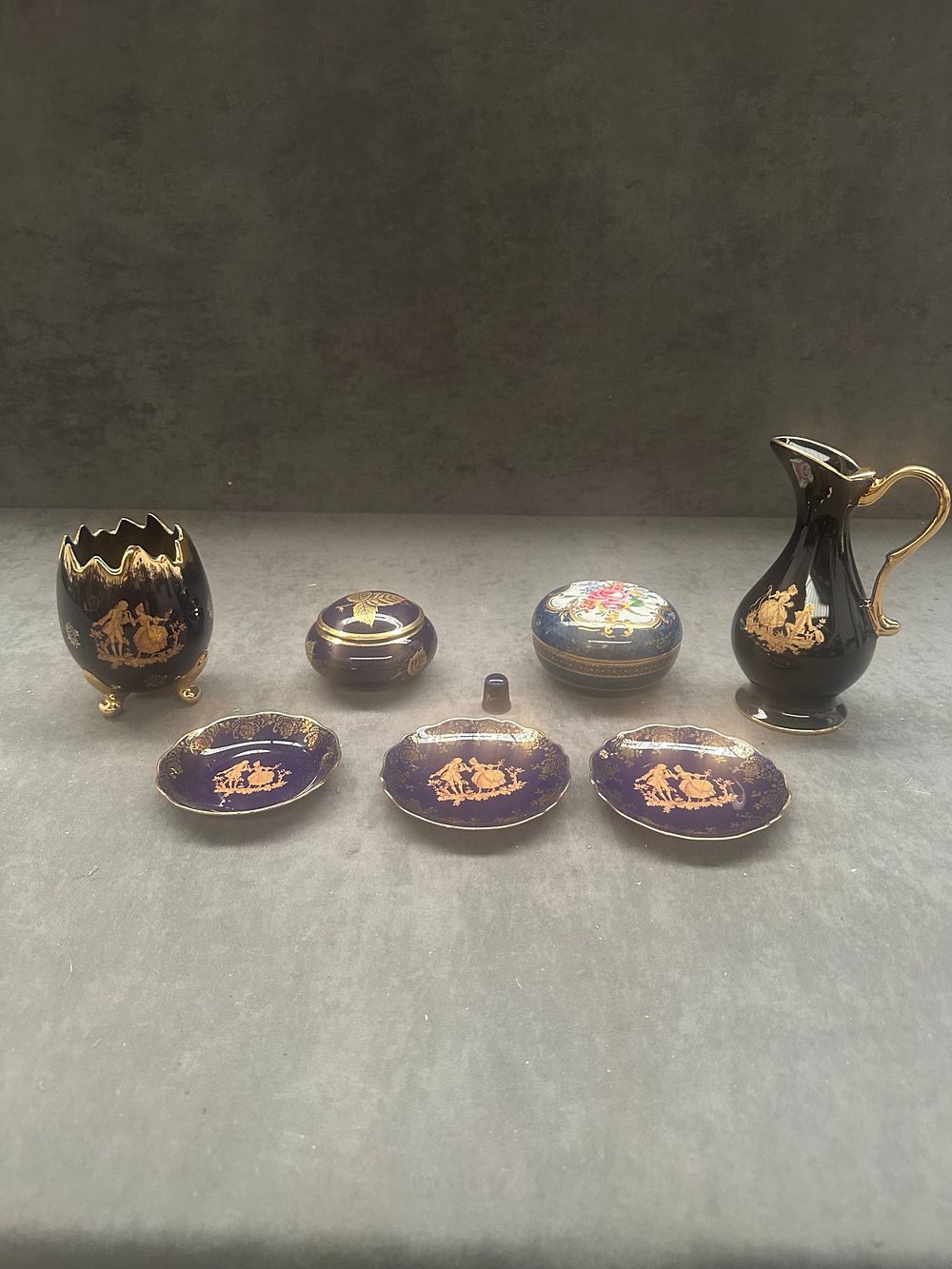 Lot 406: A collection of seven Limoges Castel cobalt blue and gold-tone porcelain cabinet pieces