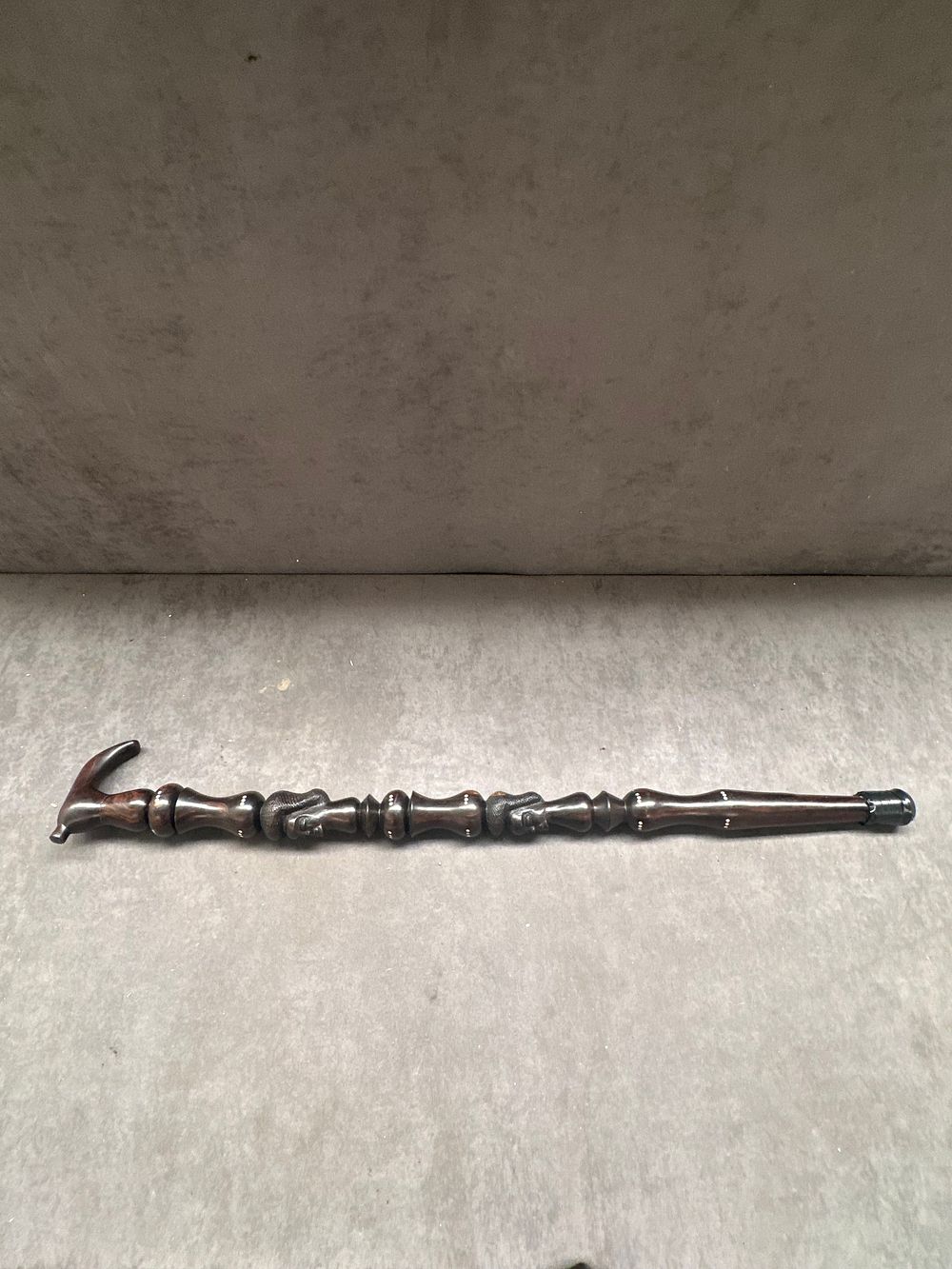 Lot 482: A Hand-Carved Hardwood Walking Stick with Figurative Relief Decoration and Bone Inlays