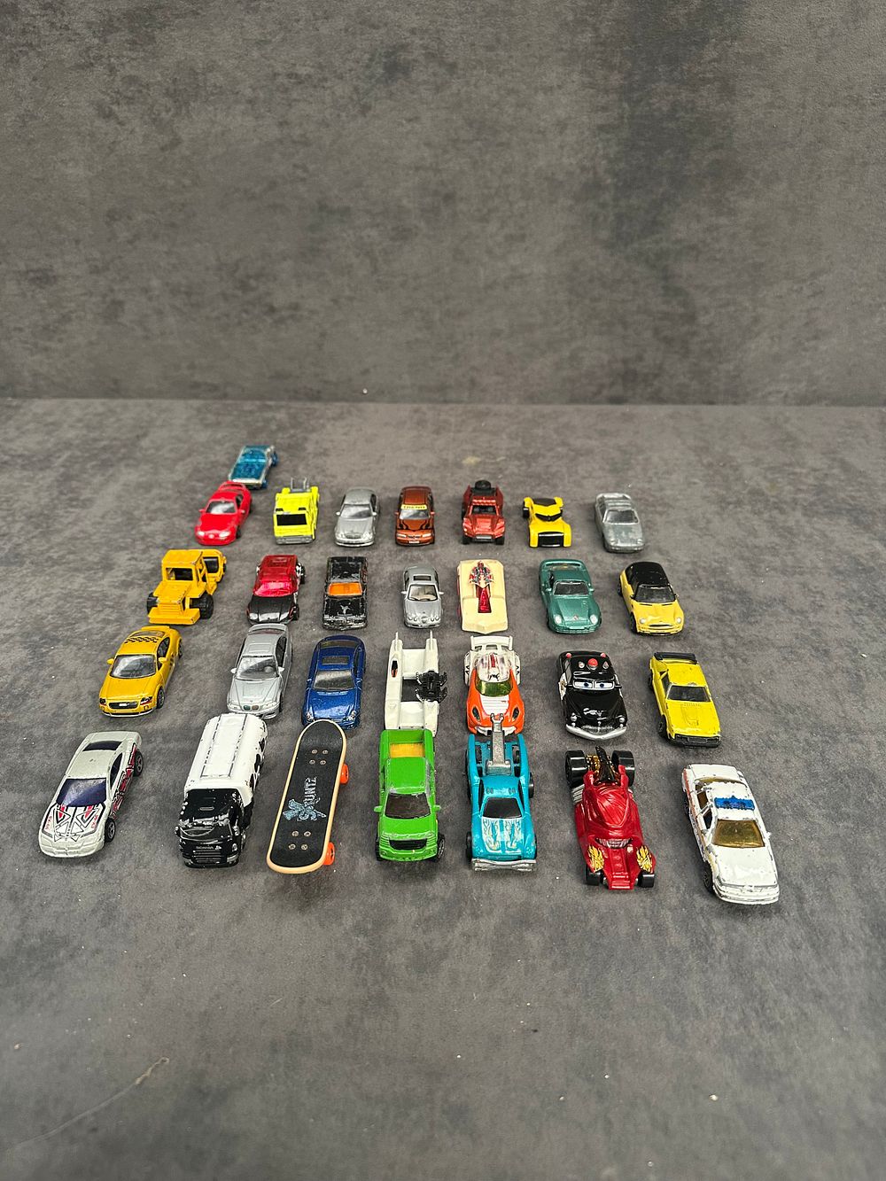 Lot 42: An Assortment of Miniature Toy Vehicles and One Skateboard