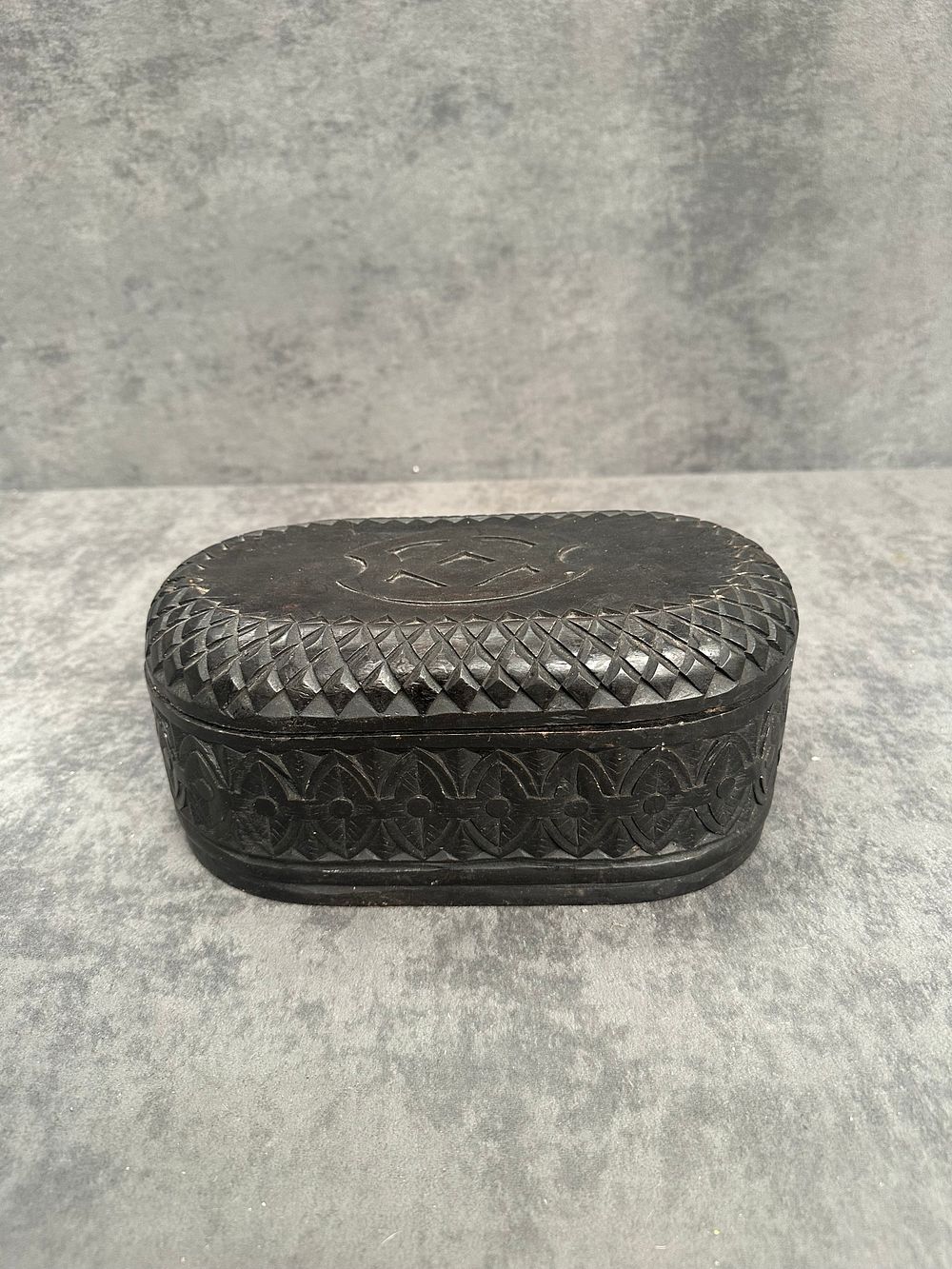 Lot 486: A hand-carved oval dark wood trinket box