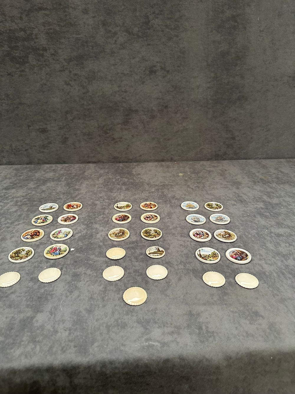 Lot 424: A Collection of 23 Miniature Porcelain Decorative Plaques with Romantic and Marine Scenes
