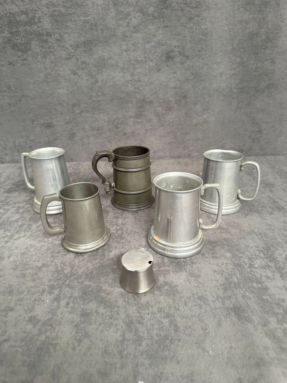 Lot 494: A Group of Five Pewter Tankards and a Small Lidded Vessel