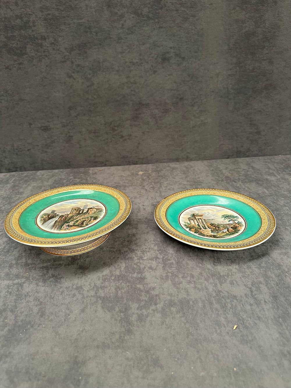 Lot 442: A Pair of Earthenware Cabinet Plates with Classical Ruins and Turquoise Borders