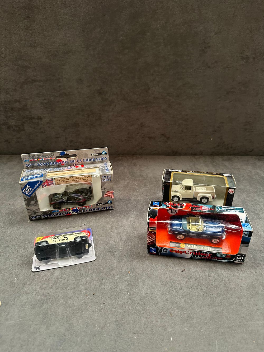 Lot 29: A Group of Four Die-cast Model Vehicles in Original Packaging