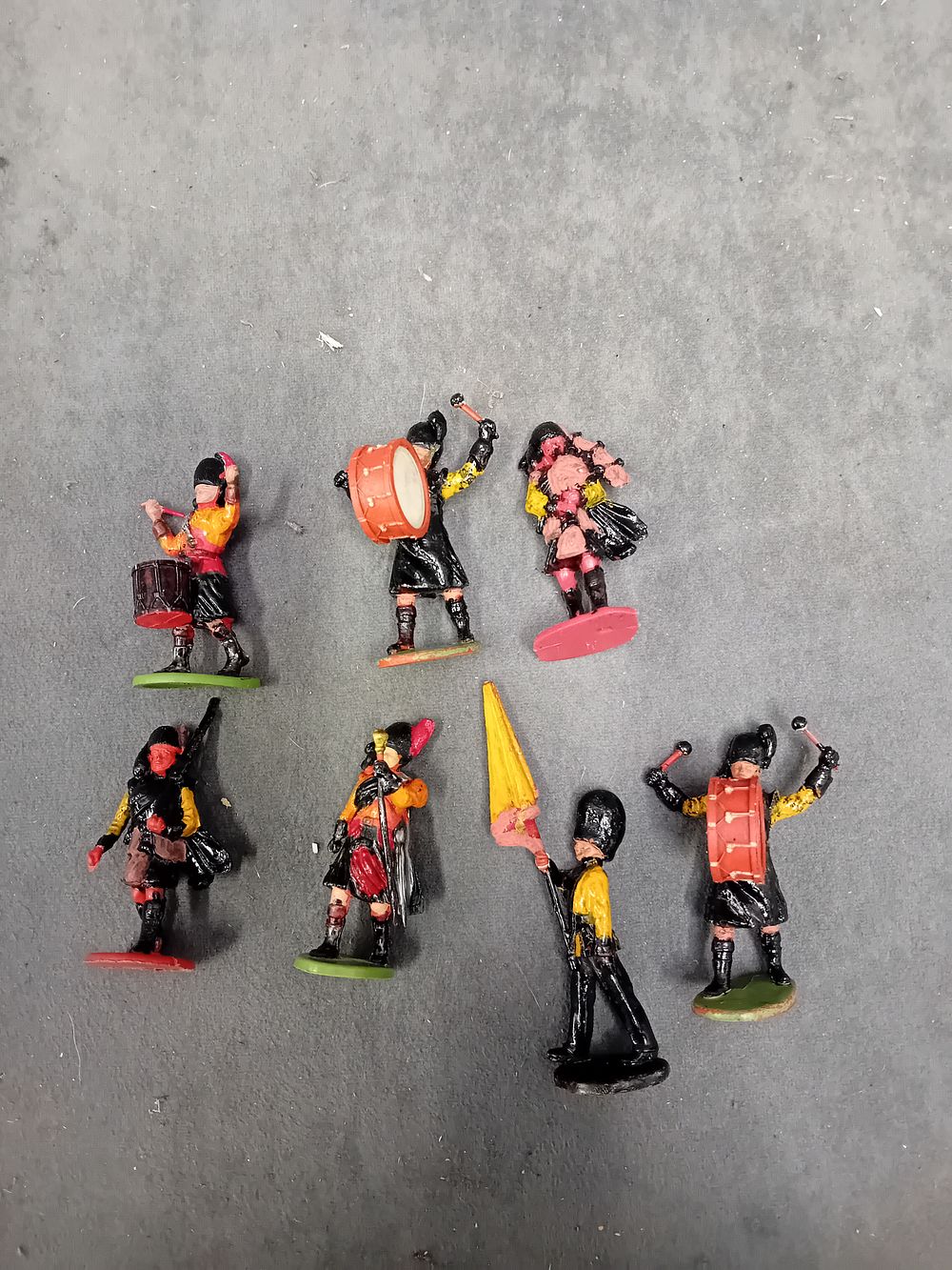 Lot 323: A Collection of (7) Hand-Painted Cast Metal Toy Figures, Scottish Highland Band and Parade Figures
