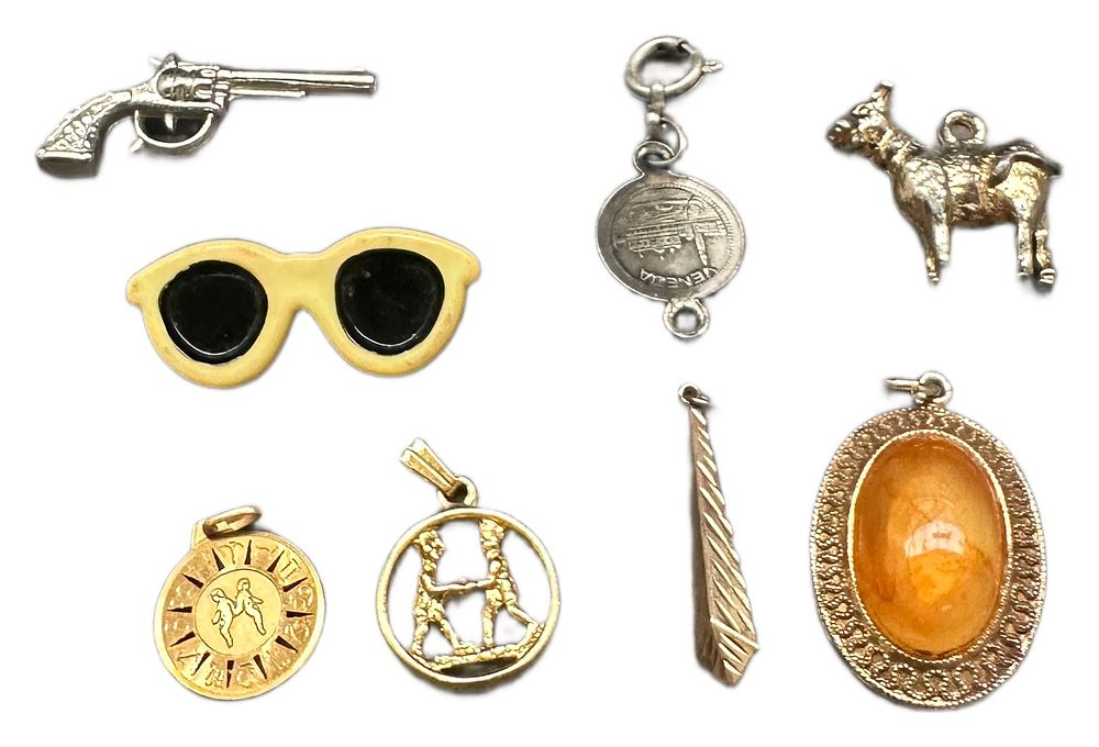 Lot 641: An Assortment of Vintage Yellow and White Metal Pendants and Charms
