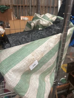 TWO PROTECTIVE PLASTIC SHEETS. Two heavy-duty protective sheets or liners. The first is a green 
