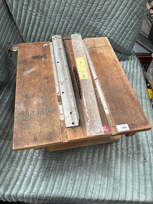A vintage benchtop circular saw with wooden housing and accessories. A vintage portable benchtop 