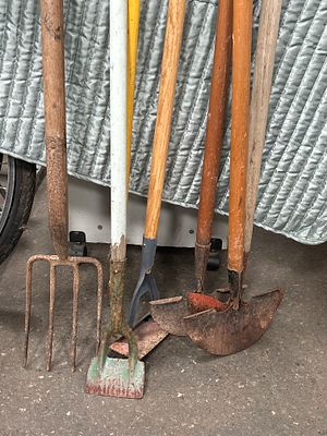 An Assortment of Vintage Garden and Hand Tools Including Handsaws and Earth Rammer. A collection 