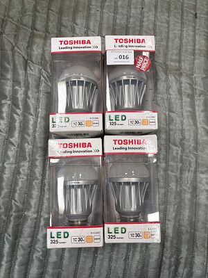 A Group of Four Toshiba E-CORE LED Light Bulbs. A group of four Toshiba E-CORE LED light bulbs 
