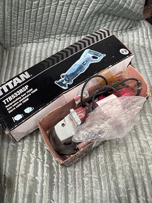 Two Corded Power Tools Including a Titan TTB533RSP Reciprocating Saw and an Angle Grinder. This 