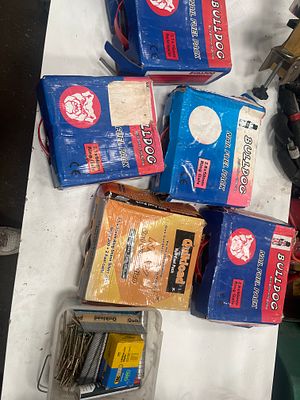 An Assortment of Bulldog and Quikload Cordless Nailer Fuel Packs and Fasteners. An assortment of 
