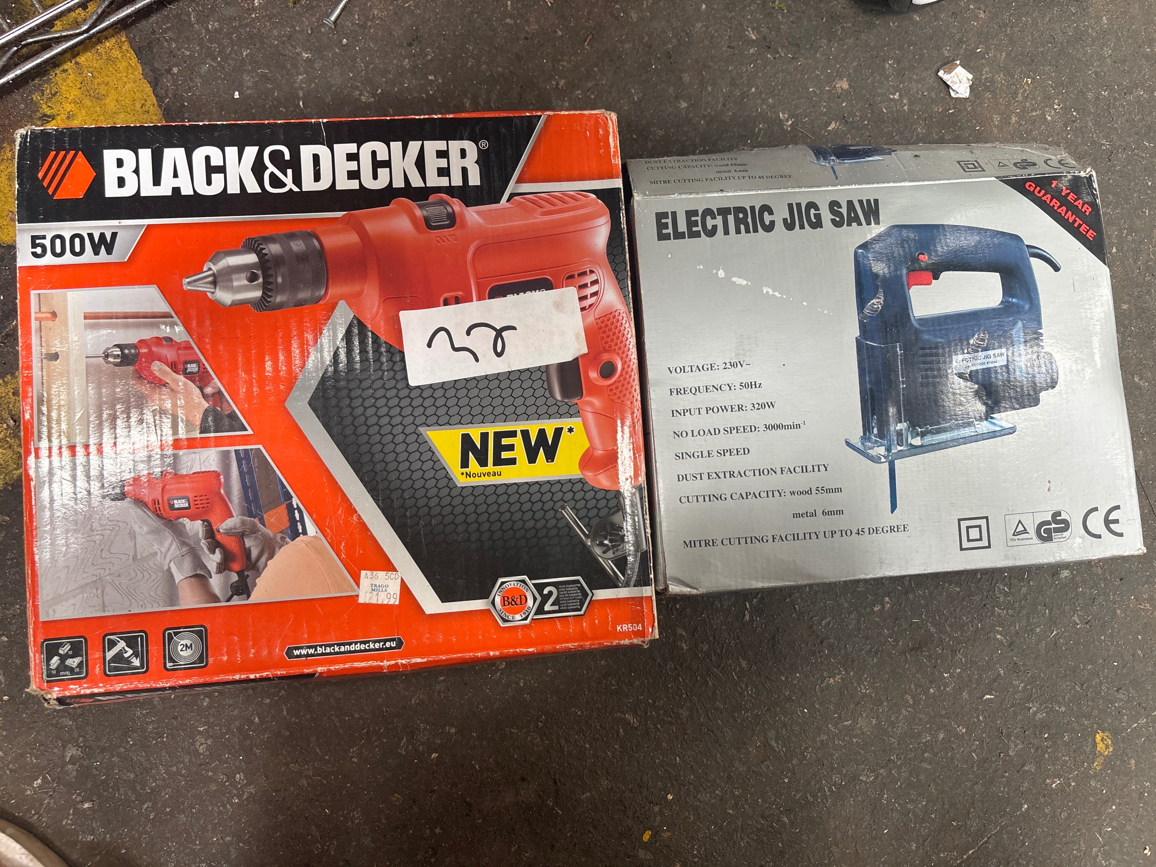 Two corded power tools comprising a Black and Decker hammer drill and an electric jig saw