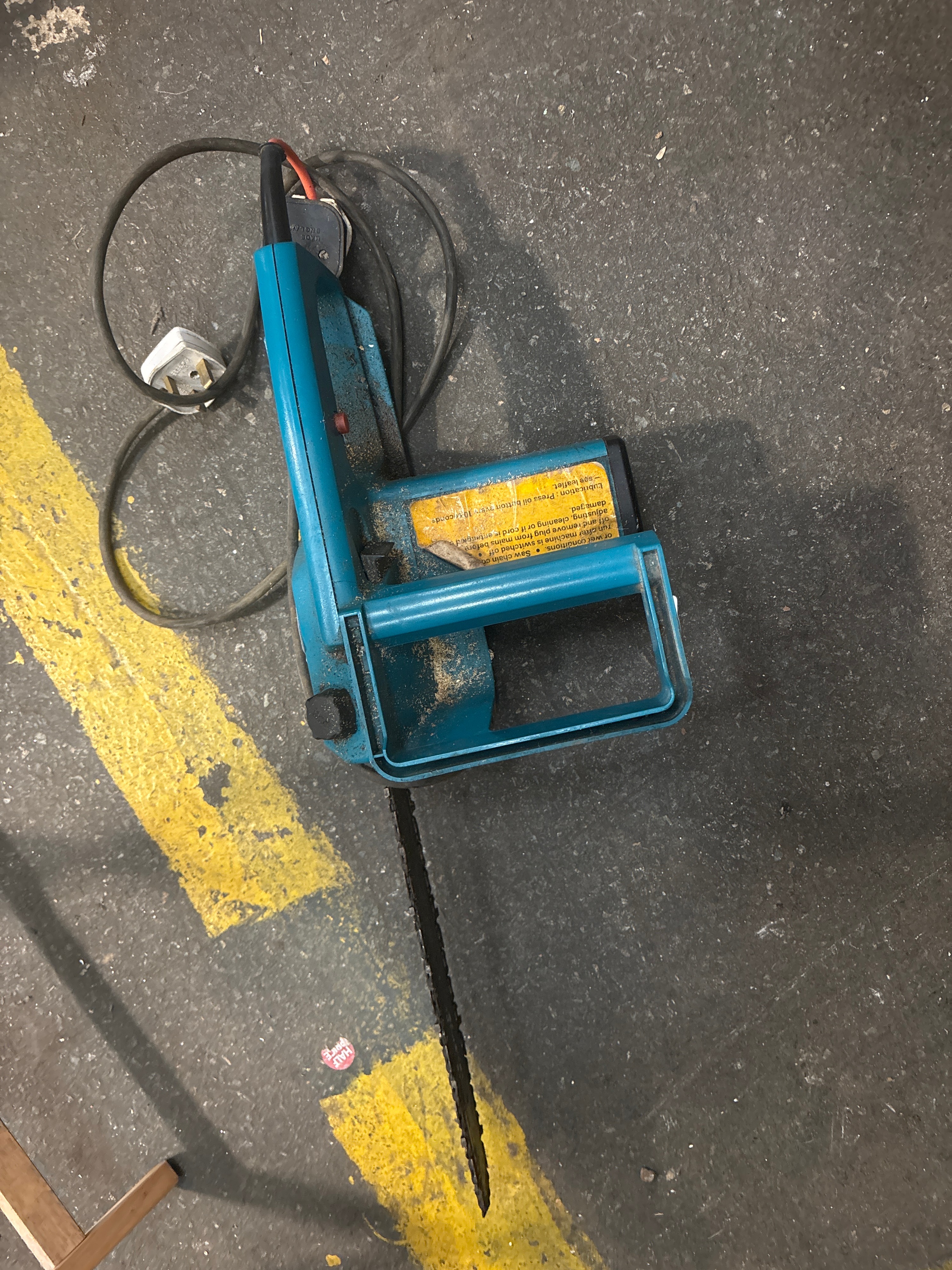 A Vintage Teal Plastic and Metal Corded Electric Handheld Chainsaw