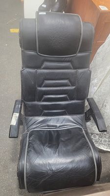 X Rocker Floor-Rocking Gaming Chair. An X Rocker floor-rocking gaming chair upholstered in black 