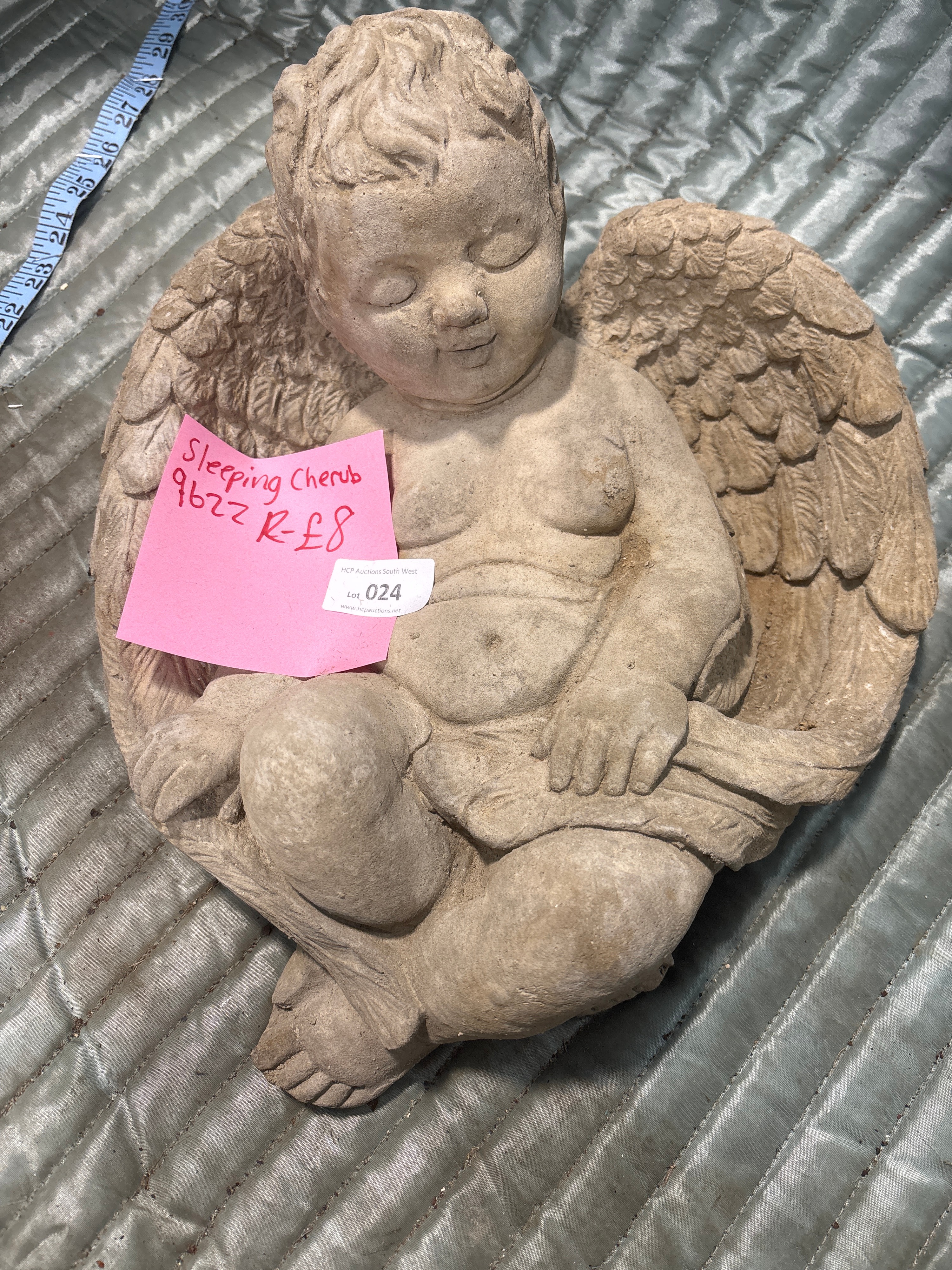 A Cast Stone Garden Ornament of a Sleeping Cherub