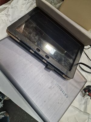 Samsung Laptop and a Folio Cased Tablet. A Samsung laptop and a tablet computer, both in a grey 