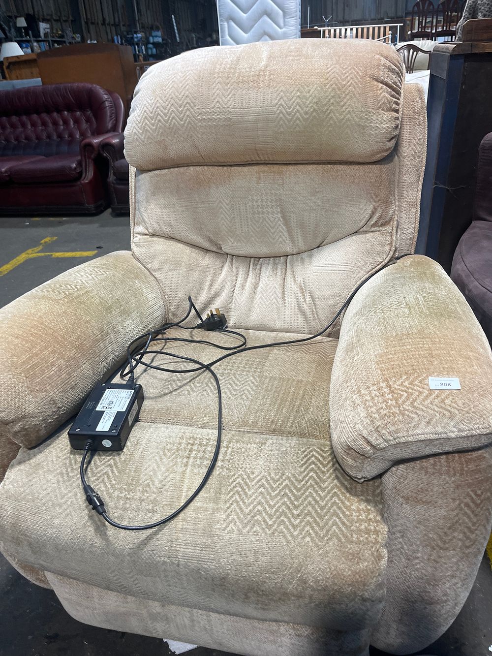 Lot 808: A Power Recliner Armchair Upholstered in Beige Chevron Fabric