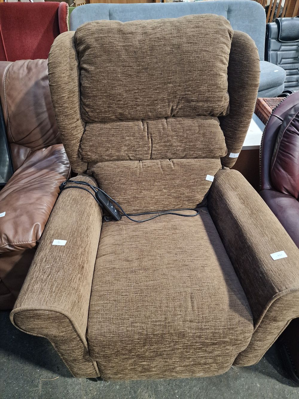 Lot 827: A Brown Fabric Electric Riser Recliner Armchair