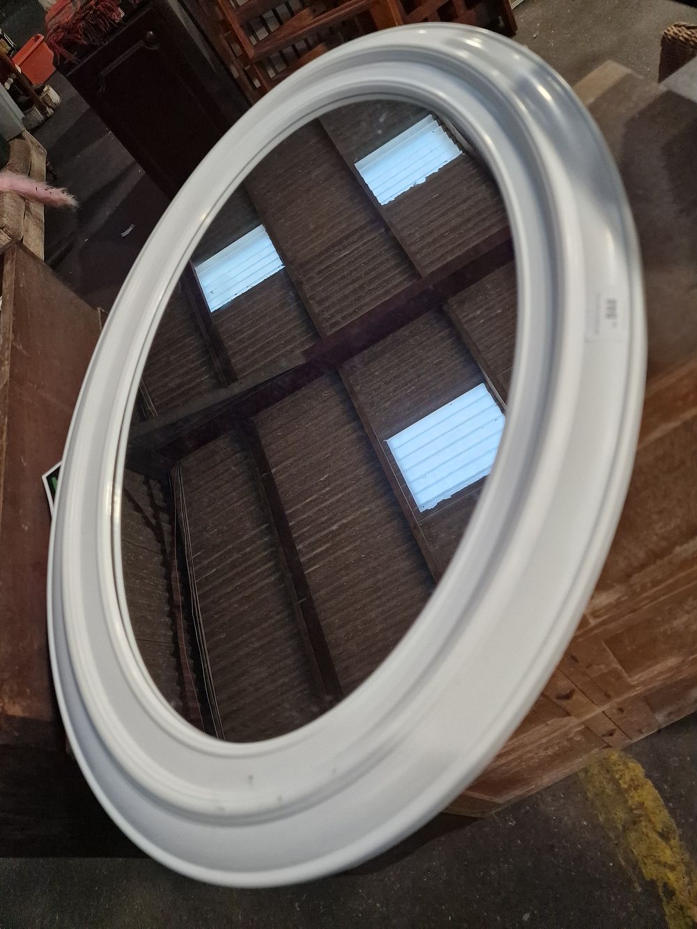 Lot 844: A Large White Tiered Moulded Oval Wall Mirror