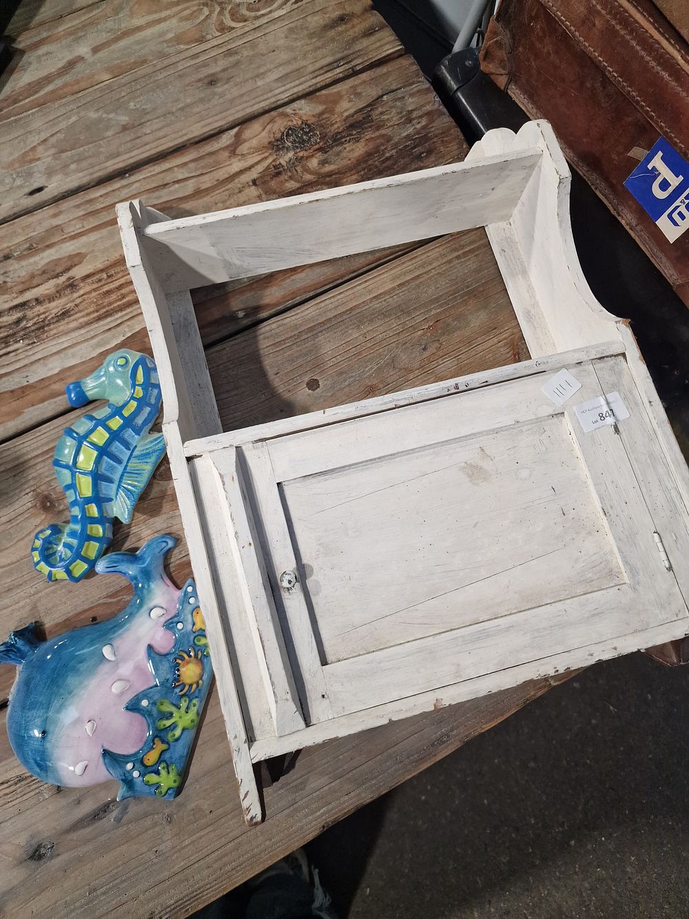 Lot 847: A Distressed White Painted Wooden Wall Cabinet and Two Ceramic Sea Life Plaques