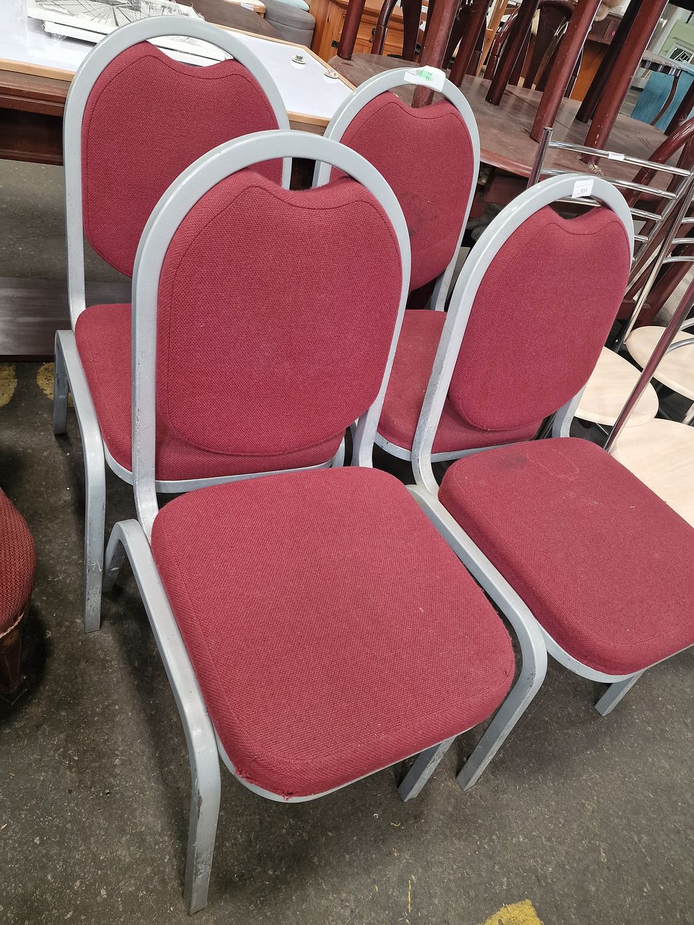 Lot 914: A Set of Red Fabric Upholstered Stacking Banquet Chairs