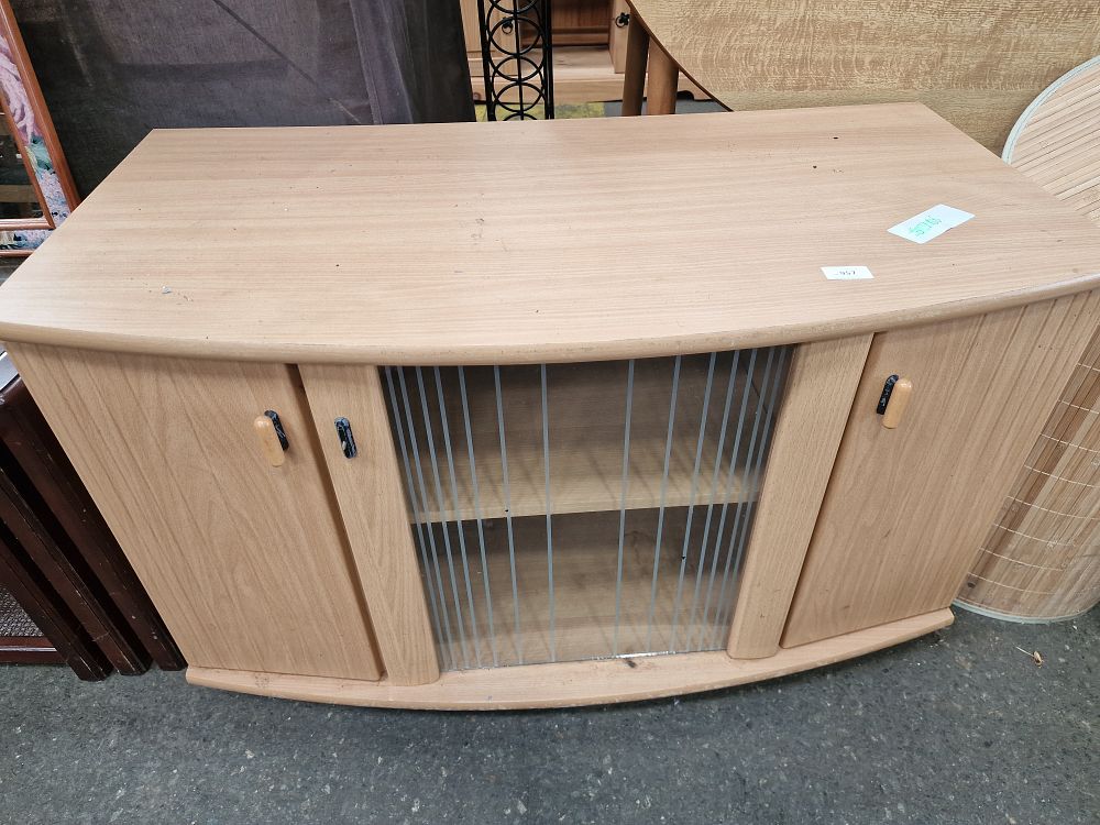 Lot 957: A Light Oak-Effect Bow-Fronted Low Television Cabinet