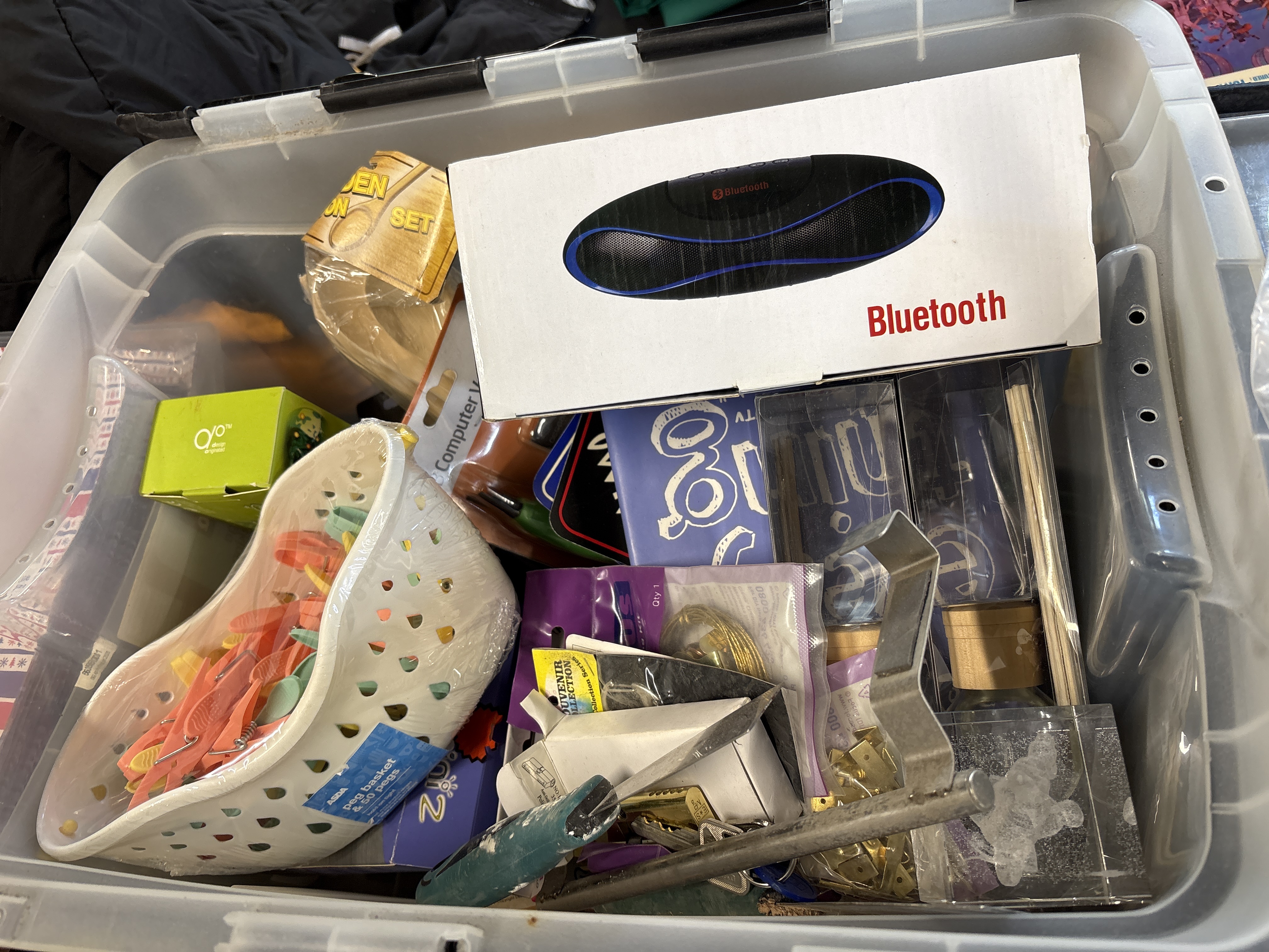 An Assortment of Miscellaneous Household Goods Electronics and Hardware Tools in Storage Bin